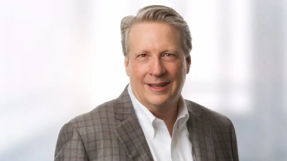 Advisory board member, Gene Dorff, for Marins Inc in a gray blazer and white shirt against a white background