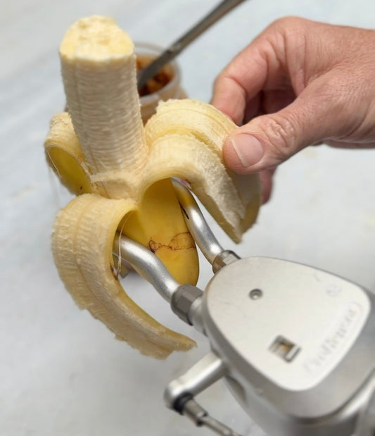 A ProHensor holding a banana while peeling with the other hand.